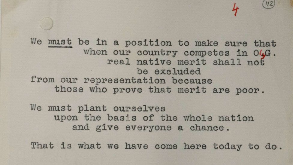 A sepia-toned close up of a paper upon which a speech by Winston Churchill was written, including handwritten correction in red