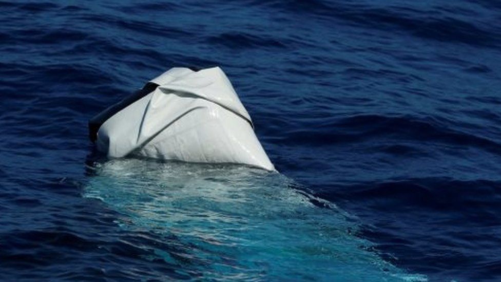 A deflated and half-sunken rubber dinghy of the sort used by migrants is seen from the Migrant Offshore Aid Station (MOAS) ship Phoenix in international waters in the central Mediterranean off the coast of Tripoli i(13 April 2017)