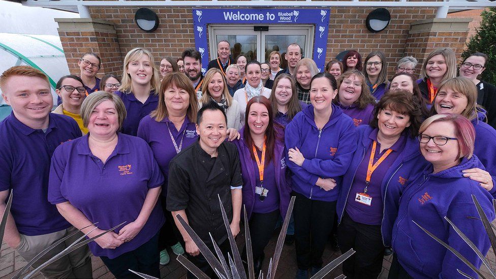 Staff standing in front of the entrance to Bluebell Wood Children's Hospice