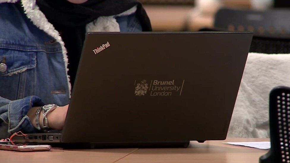 File image of an anonymous young woman using a Brunel-branded laptop on campus.