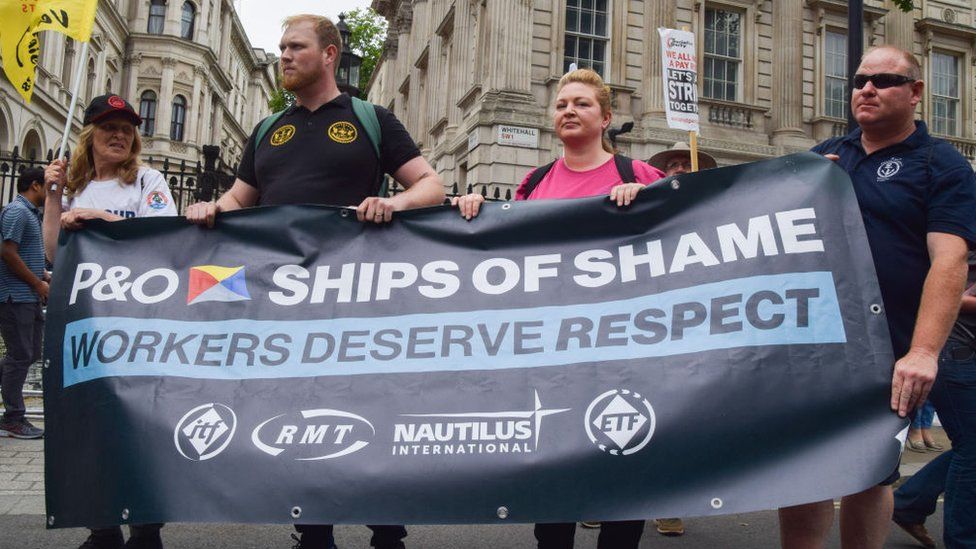 Protesters hold a banner in support of P&O Ferries outside Downing Street