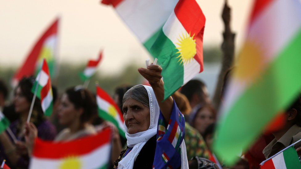 Iranian Kurdish women hold a Kurdish flag at a gathering to urge people to vote in the upcoming independence referendum in Bahirka, in the Kurdistan Region of Iraq (21 September 2017)