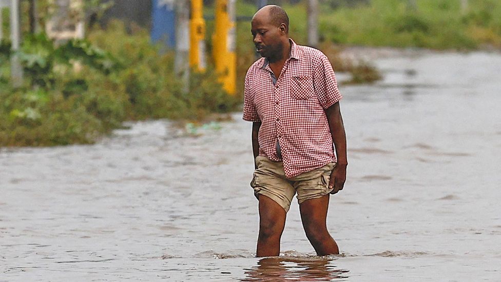 Man walking through a flooded road