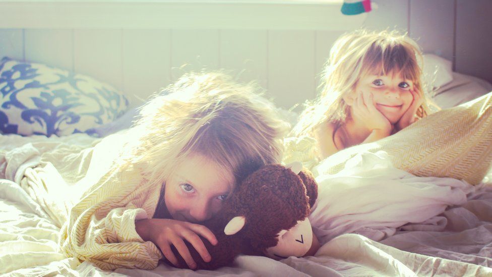 Two girls waking up