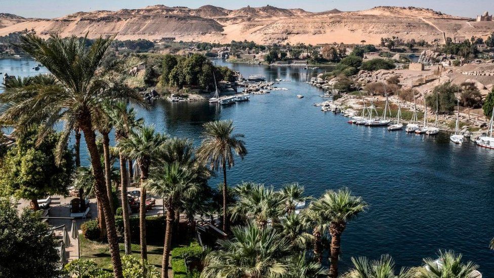 This picture taken on January 3, 2021 shows a view of Aswan from the Old Cataract Hotel overlooking the Nile river in Egypt's southern city of Aswan, some 920 kilometres south of the capital, where British crime fiction writer Dame Agatha Christie is believed to have stayed while writing her 1937 novel "Death on the Nile", with the Mausoleum of Aga Khan III seen in the background (top R).