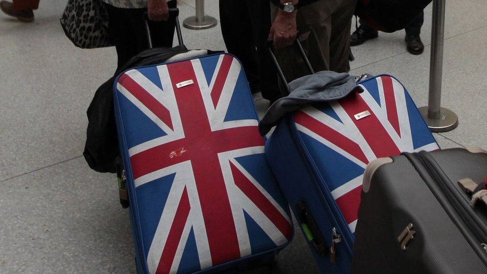 Suitcases decorated with the UK flag