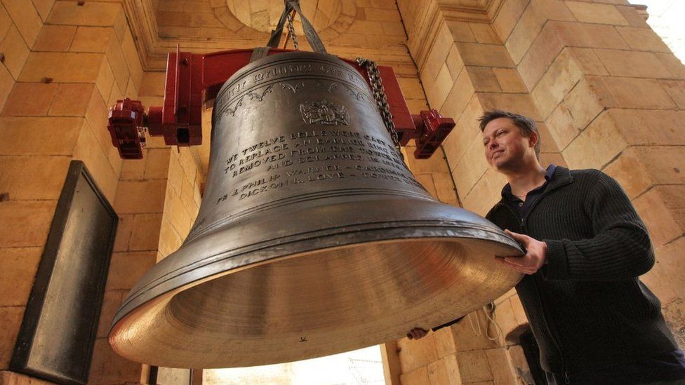 Dickon Love manoeuvres a bell into the church of St Magnus the Martyr in 2009