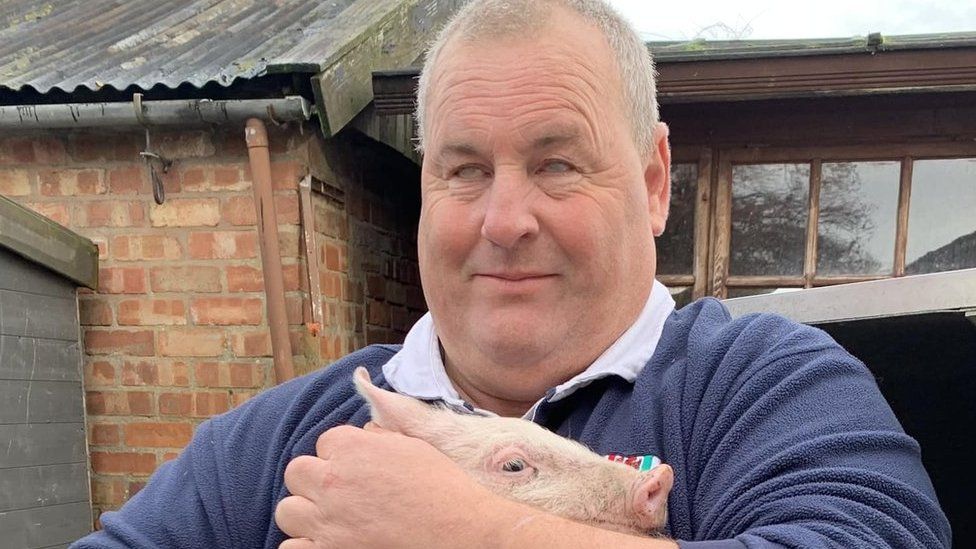 Mike Duxbury holding a pig