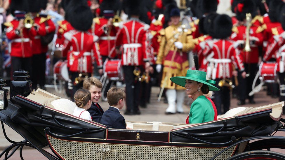 Queen, Kate and grandchildren travel in a carriage in the procession