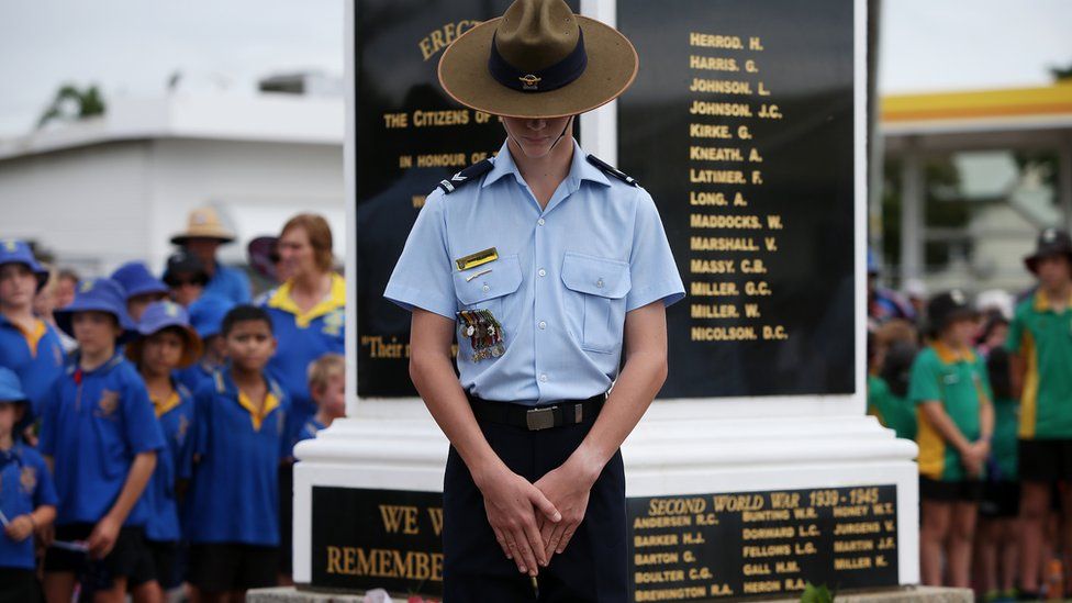 A young Australian Air Force Cadet bows his head at the Bowen Cenotaph during an Anzac Day wreath laying ceremony in Bowen, Australia, 25 April 2019