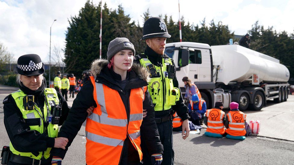 An activist is led away from the blockade of the Tyburn fuel depot in Birmingham