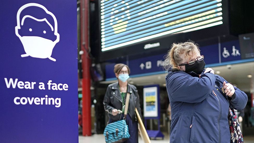 People wear face masks at the train station on July 14, 2020 in Liverpool