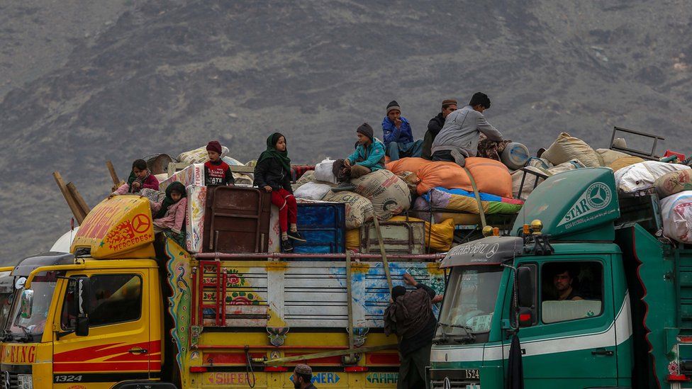 Afghan refugees unload their belongings from trucks as they arrive at temporary shelters in a tent camp after returning from neighbouring Pakistan, at the Afghanistan-Pakistan border in Toorkham, Afghanistan, 18 November 2023