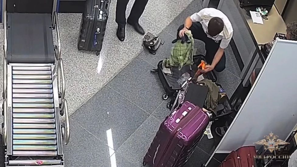 Fogel being searched at the airport