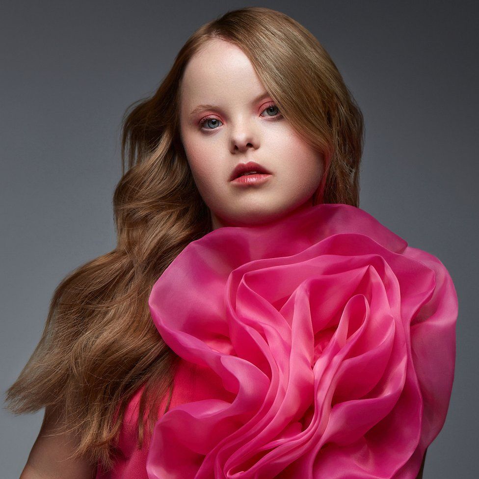 Beth in a pink dress posing for Cosmopolitan Bulgaria for World Down Syndrome Day March 2023