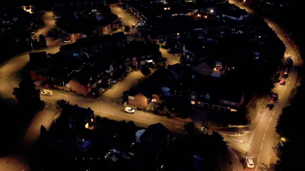 An aerial view of unidentified suburban streets in the UK, taken at night