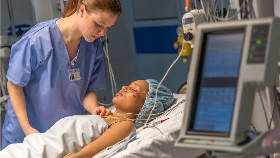 Doctor looking after critically ill patient