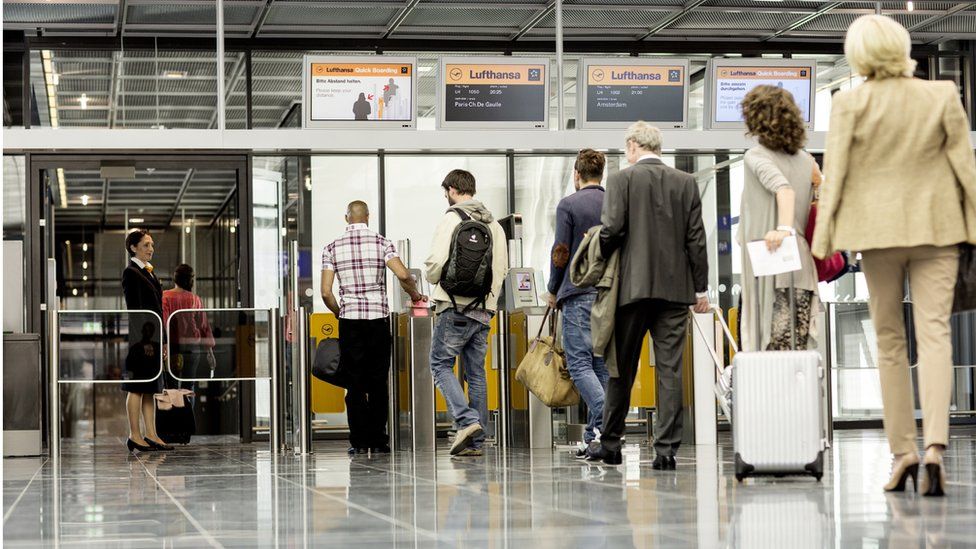 Passengers queuing up at airport check-in