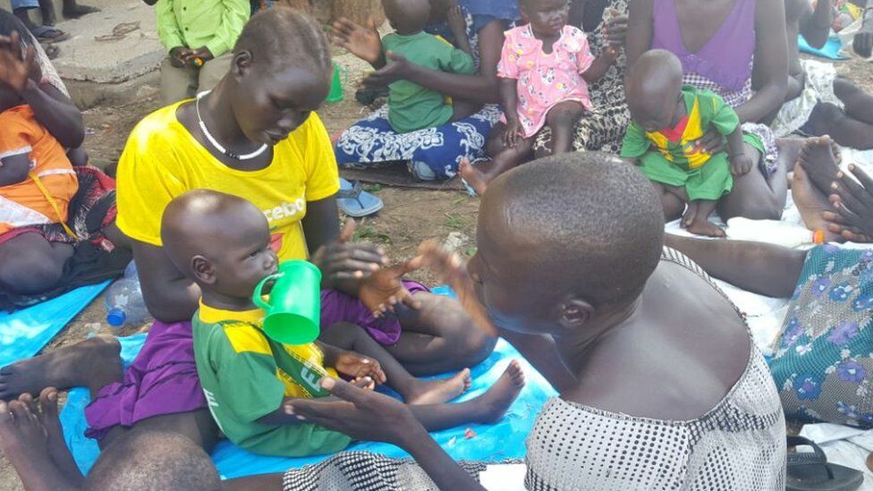 People looking after children rescued from their South Sudanese captors, Gambella, Ethiopia