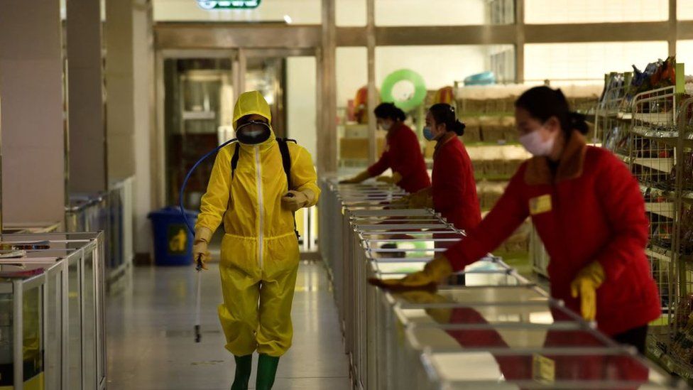 Employees spray disinfectant and wipe surfaces as part of preventative measures against the Covid-19 coronavirus at the Pyongyang Children's Department Store in Pyongyang on March 18, 2022.