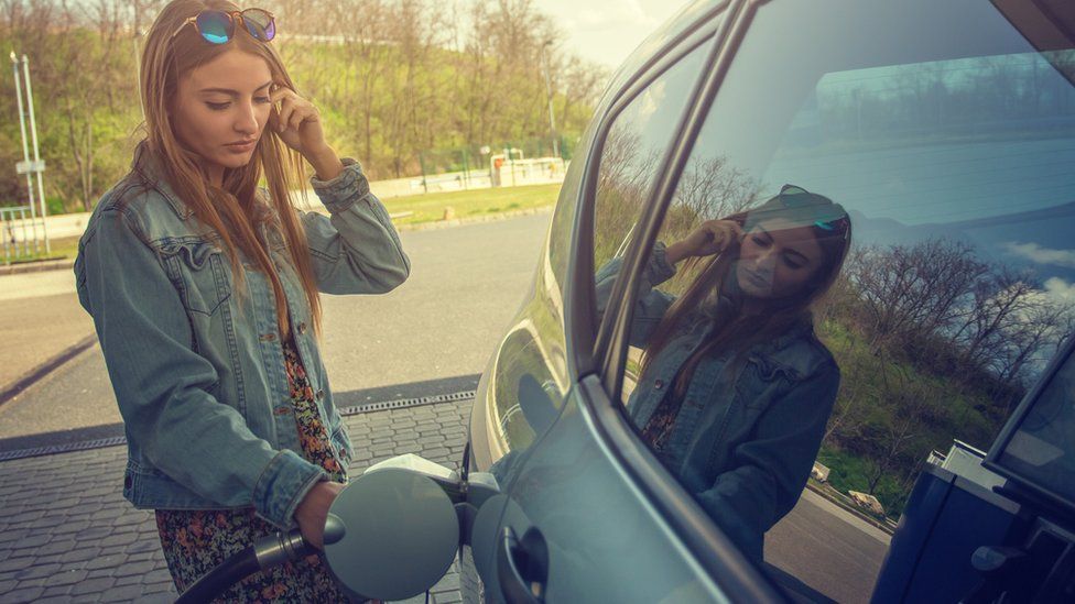 Woman filling car