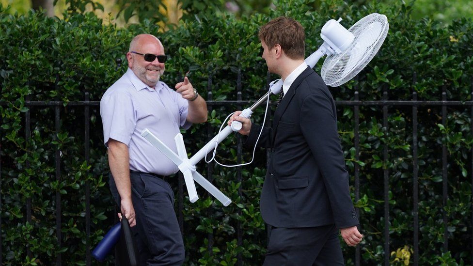 An office worker carries a fan in Westminster