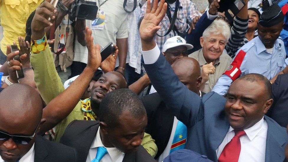Jean-Pierre Bemba waving amidst crowds in Kinshasa, DR Congo