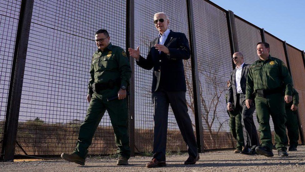 President Biden walks with border agents along a section of wall between the US and Mexico