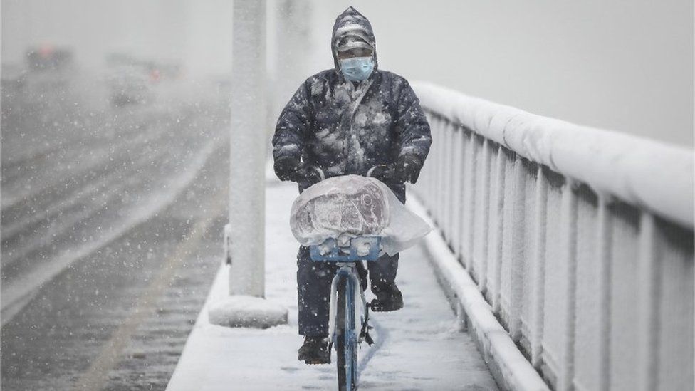 A man riding a bike in Wuhan - the epicentre of the coronavirus outbreak in China, 15 February 2020