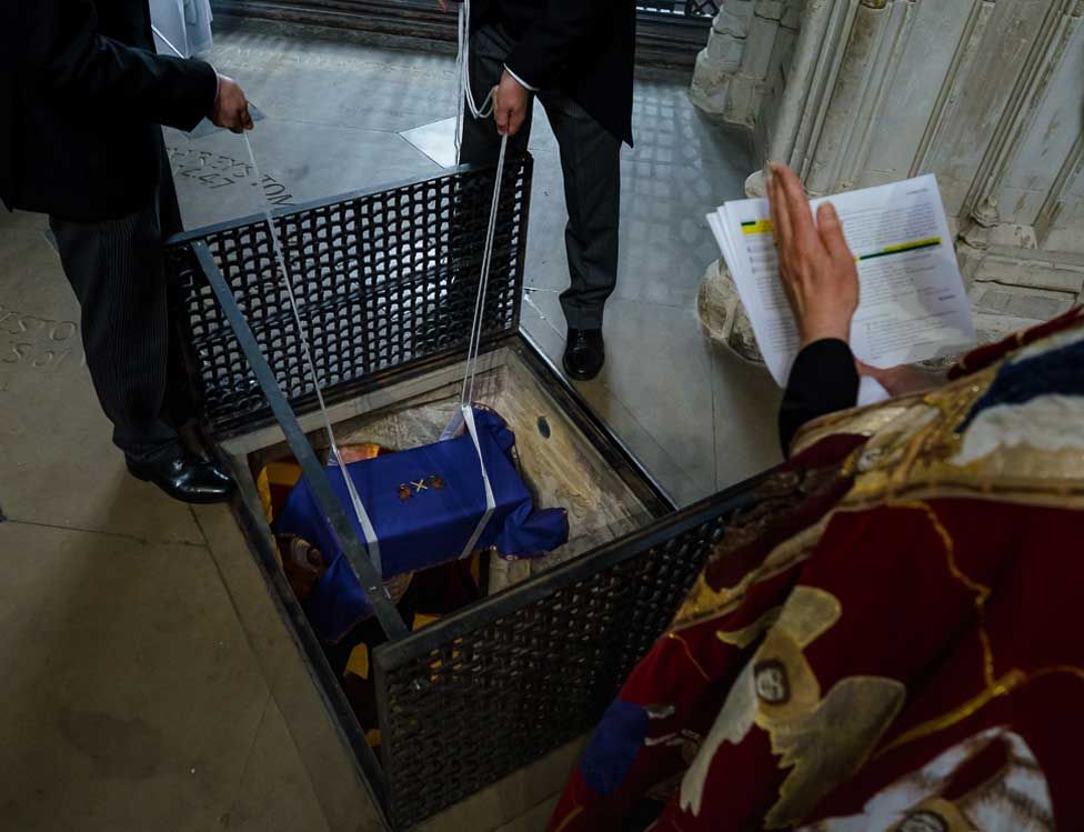 Abbot John's ossuary is lowered into the Chantry Chapel