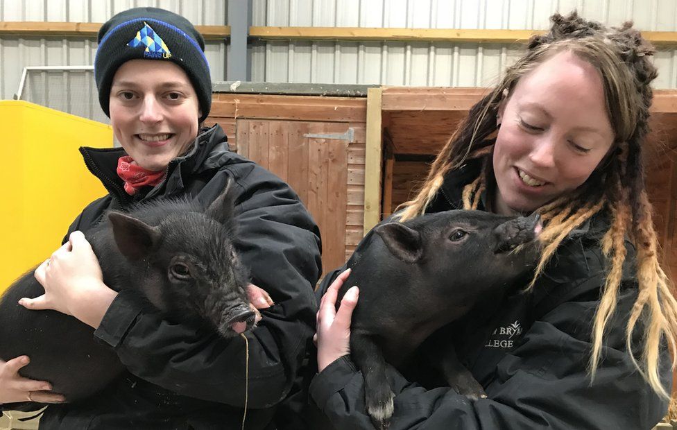 (Left to right) Askham Bryan College animal keeper Molly Lownsbrough and piglet Stockings and lead animal keeper Lucynda Hodgson and piglet Star.