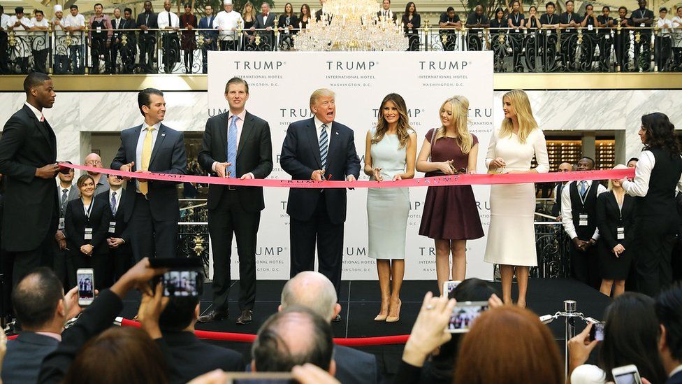 Republican presidential nominee Donald Trump (C) and his family (L-R) son Donald Trump Jr, son Eric Trummp, wife Melania Trump and daughters Tiffany Trump and Ivanka Trump cut the ribbon at the new Trump International Hotel October 26, 2016 in Washington, DC.