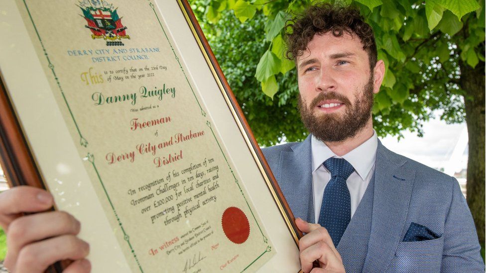 Danny Quigley holding certificate conferring freedom of city of Derry