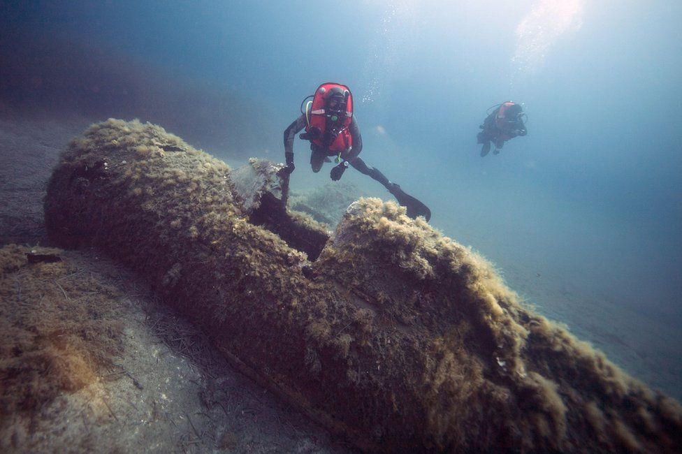 A French military diver member of the FS Pluton M622 navy de-mining ship, swims on July 2, 2018, above the wreck of an USAAF P-47 Thunderbolt (Warthog) US fighter plane