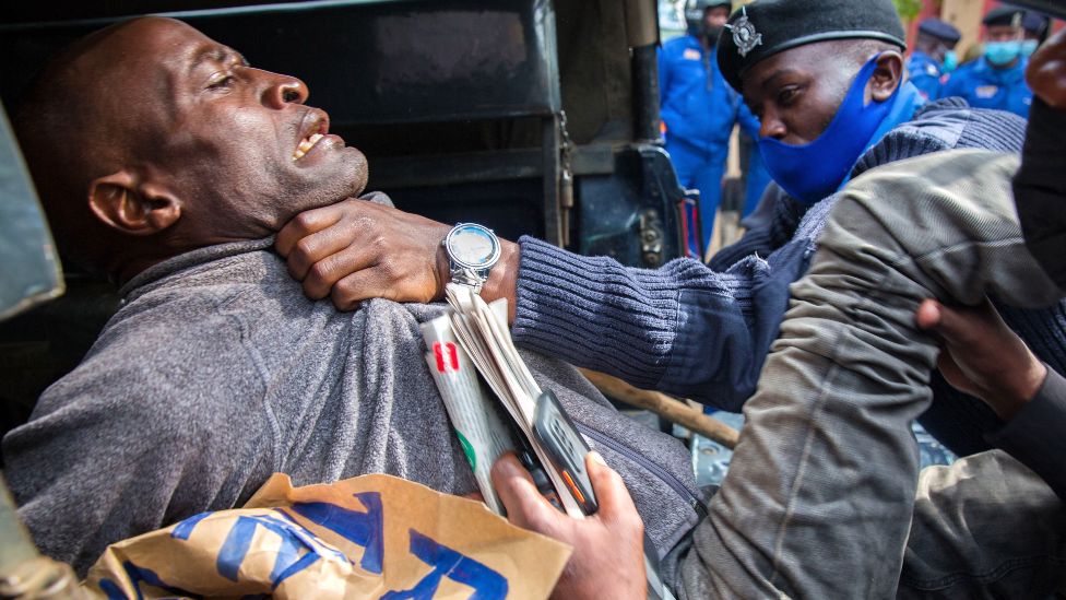 A protester being manhandled by a police officer in Nairobi, Kenya - Saturday 1 May 2021