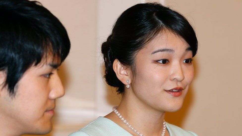 Princess Mako (R), the eldest daughter of Prince Akishino and Princess Kiko, speaks as her fiancee Kei Komuro (L), looks on during a press conference to announce their engagement at the Akasaka East Residence in Tokyo on 3 September 2017.