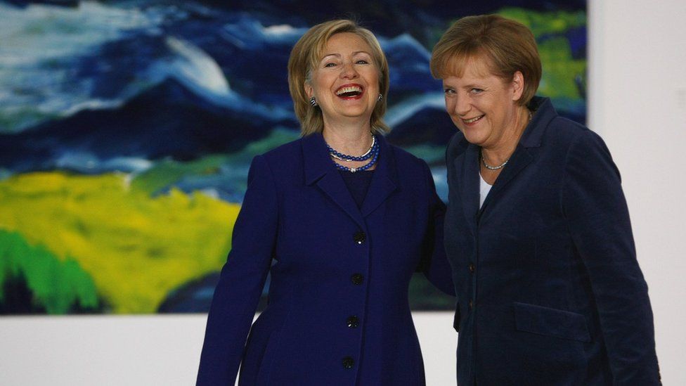 Hillary Clinton and Angela Merkel laughing together
