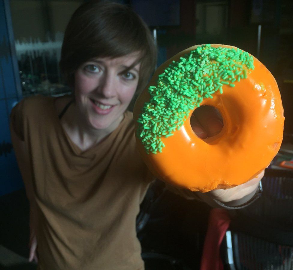 Doughnut held up by Anna Doble