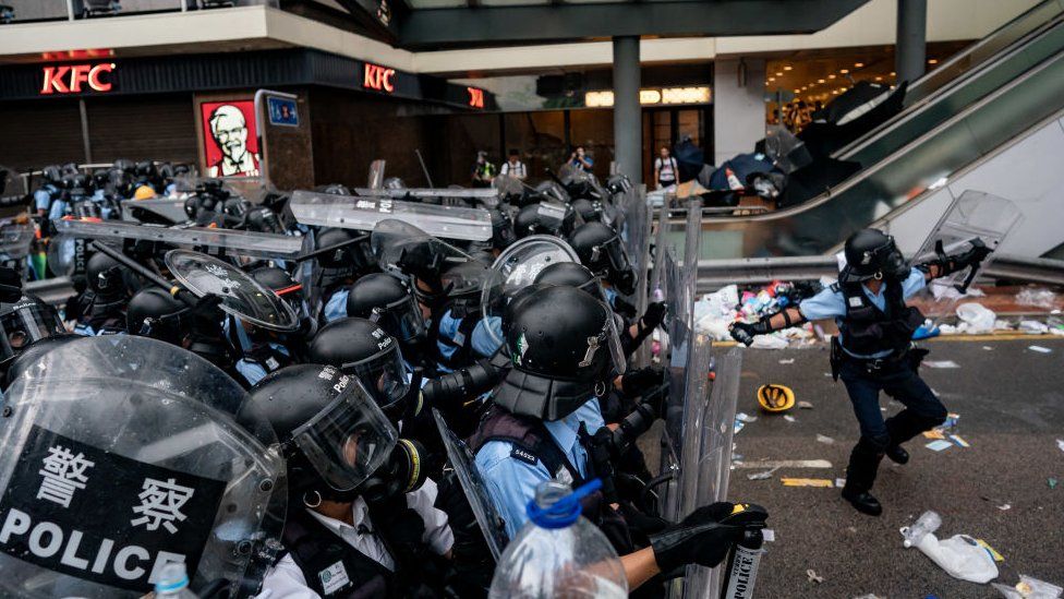 A police officer throws a teargas canister during a protest on June 12, 2019 in Hong Kong China