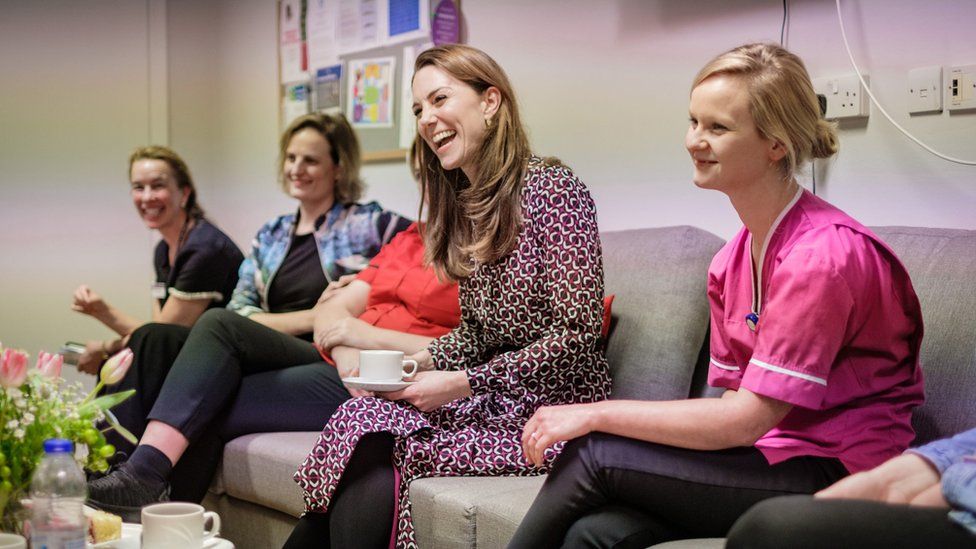 The Duchess of Cambridge laughs with staff at Kingston Hospital's maternity unit