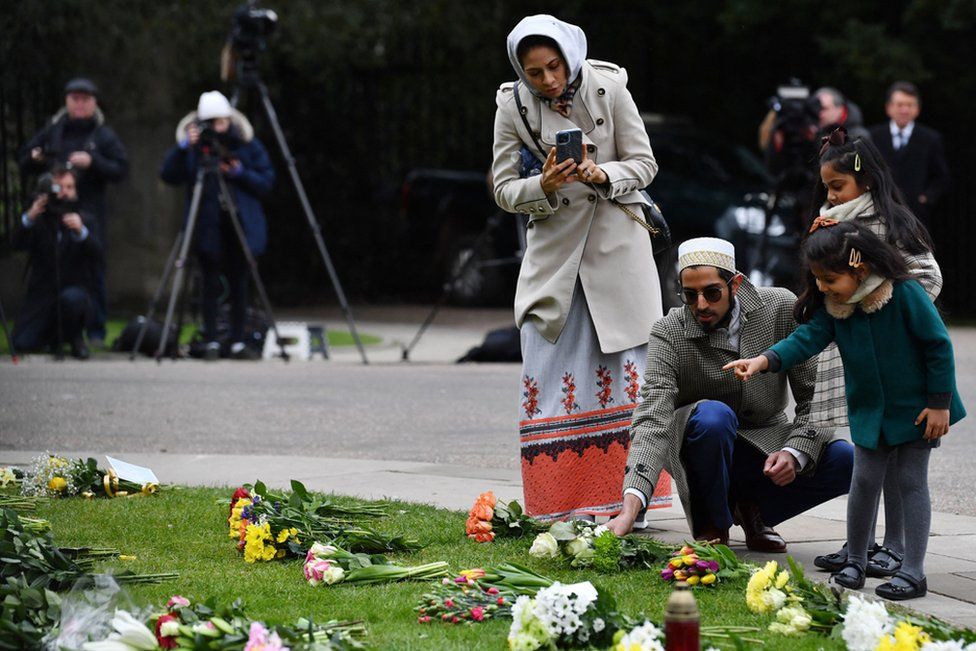 Well-wishers lay a floral tribute in honour of Britain's Prince Philip, Duke of Edinburgh outside Windsor Castle in Windsor, west of London, on April 10, 2021