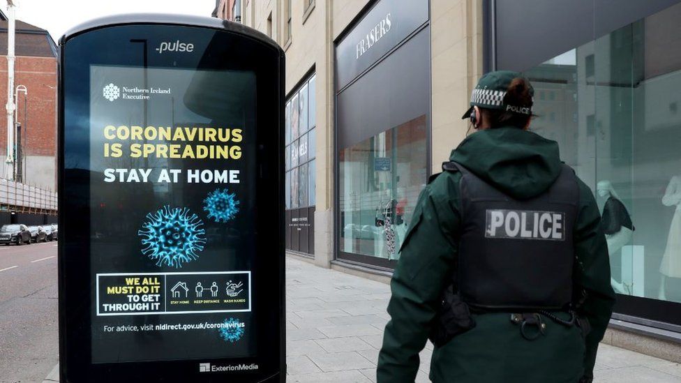 Undated handout photo issued by PSNI showing an officer on patrol in Belfast city centre during the coronavirus lockdown