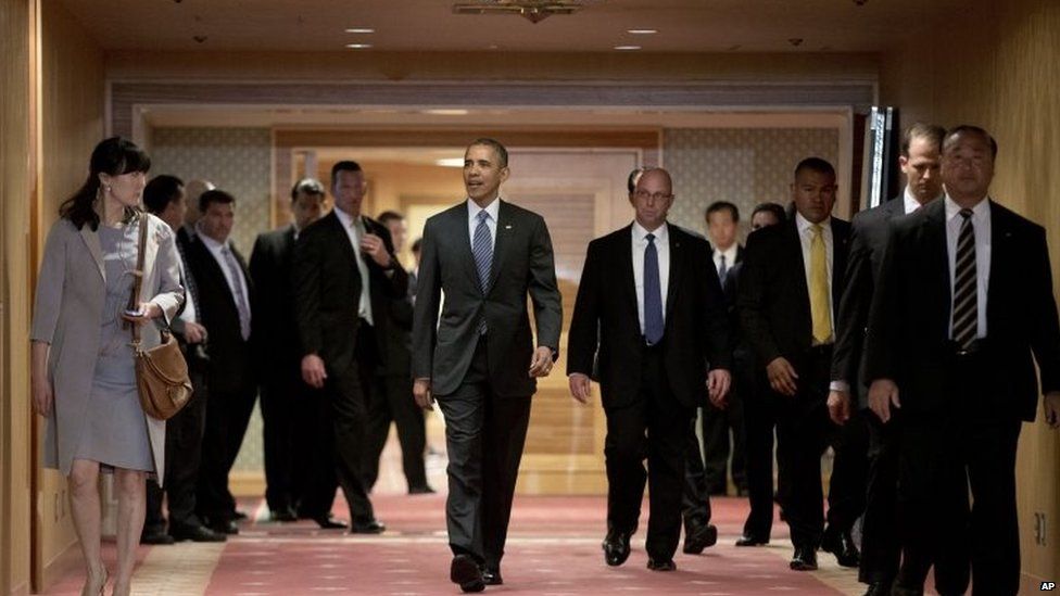 U.S. President Barack Obama walks to greet Japan's Emperor Akihito and his wife Empress Michiko as they arrive at the Okura Hotel in Tokyo 25 April 2015