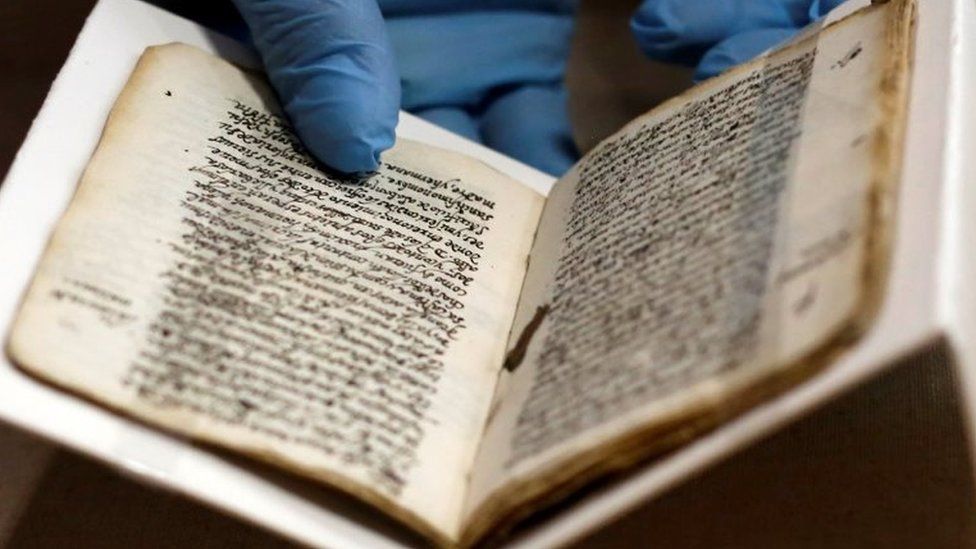 An employee holds the 16th-century manuscript by Spanish-born Jew Luis de Carvajal the Younger as it is displayed to the media at the Anthropology museum in Mexico City, Mexico March 23, 2017.