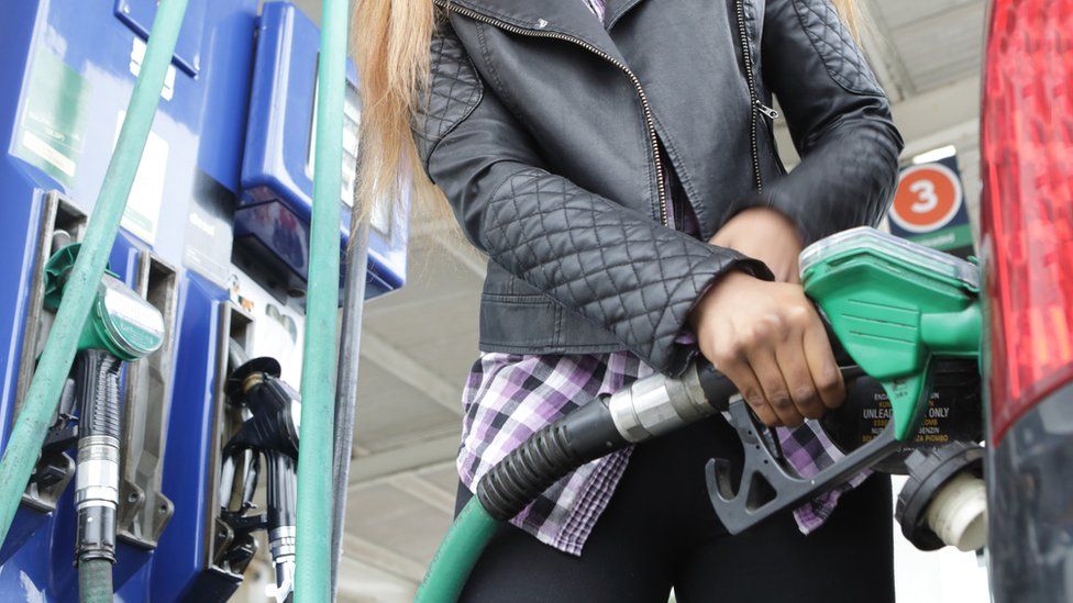 Woman using petrol pump