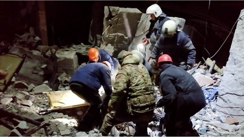 Emergency responders retrieve bodies from the rubble of the destroyed bakery building