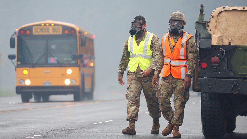 Hawaii National Guard soldiers wear masks to protect themselves from volcanic gases in Pahoa during ongoing eruptions of the Kilauea Volcano in Hawaii, U.S., May 17, 2018