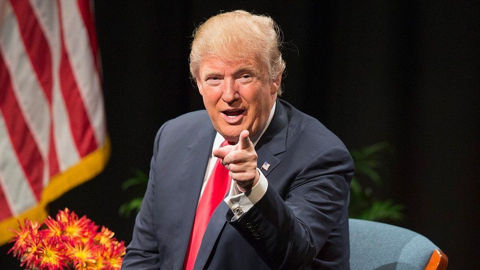 Republican presidential candidate Donald Trump points at the camera.