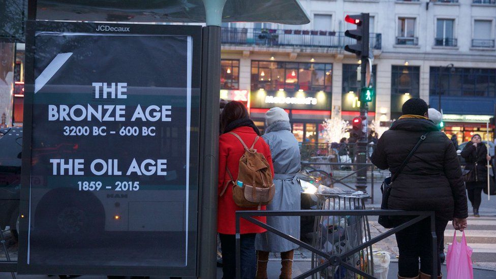 A poster reading "The Bronze age - 3200 BC to 600 BC; The Oil age - 1859-2015"