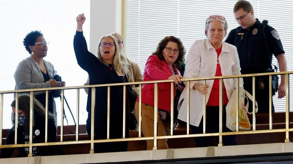 Protesters were forced out of the Senate after the bill was passed on Thursday